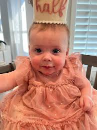 I was hoping someone could fix this picture to have her dress down and  blurr out the background and give it a nice pink or white back drop. I  added a picture