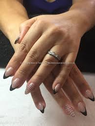Almond Shaped Acrylic Nails With Black Tips Eye Candy Nails Training Almond Shaped Acrylic Nails With Black Tips And Dots On Ring Fingers By Jade Mccluske Nails Sensational Nails Natural Nail Designs