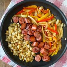 Smoked sausage or kielbasa, diced potatoes and slices of peppers and onions make an easy and delicious skillet meal. Smoked Sausage Peppers Onions Potatoes Skillet Plowing Through Life