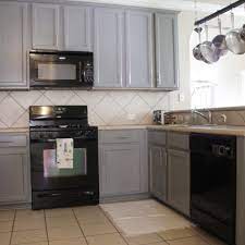 The color on the kitchen tile has a slight hint of blue to give it some interest. Gray Kitchen Cabinets With Black Appliances Kitchen Cabinets With Black Appliances Small Kitchen Cabinets Grey Kitchen Cabinets