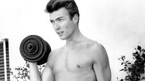 He is pointing the guns he holds in each hand toward the camera. Clint Eastwood Photos Show The Hollywood Veteran As A Shirtless 26 Year Old Herald Sun
