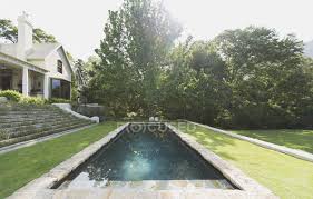 This outdoor fountain is easy to move around, thanks to its lightweight resin construction. Pool Against Trees At Luxury Modern House Scene Design Stock Photo 199348096