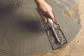 You could rent a heavy duty floor sander and use silicone carbide sandpaper to abraid the entire floor surface thereby repairing the area of concern at the same time. How To Patch A Concrete Floor This Old House