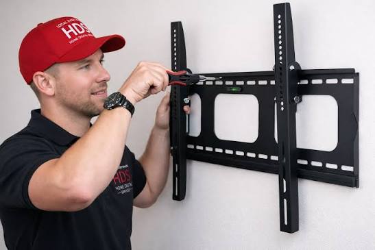 Crayford fitter hiding TV cables behind wall bracket