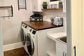 A countertop panel and wall cabinet were installed to create vertical storage this laundry space only has room for a small washing machine. The Top 64 Small Laundry Room Ideas Interior Home And Design