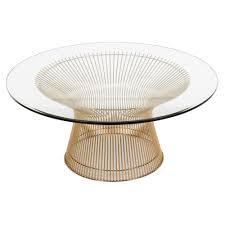 The table top is a transparent tempered glass which shows off the architectural connection and carries the rectangle table top design through the frame. Rumsey Coffee Table In Gold Gh60674 By Galla Home
