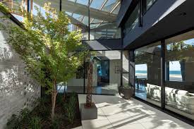 This home is located high on a hill with expansive views west from the manukau heads through to the gulf islands and the coromandel to the east. Designinc Bio Courtyard House Designinc