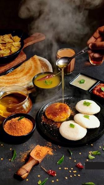 Complete South Indian breakfast platter with crispy masala dosa, coconut chutney, sambar, and filter coffee on a wooden table