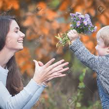 Not only are they beautiful and feminine, they're often symbolic, too. Child Gives To Happy Mother Flowers Fall Colors Background Stock Photo Picture And Royalty Free Image Image 65559586