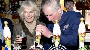 Camilla pour pints at village pub