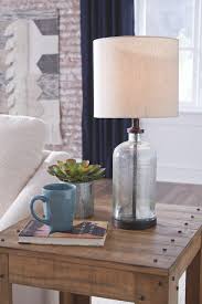 Uncover our beautiful collection of table lights for use all around the home. The Bandile Clear Bronze Finish Glass Table Lamp 1 Cn Available At Furniture Connection Serving Clarksville Tennessee And Ft Campbell Kentucky