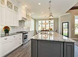 Gold light pendants light a white and gold granite island countertop fitted with a sink and polished nickel. Grey Kitchen Cabinet With Granite Countertops Google Search Grey Kitchen Cabinets White Modern Kitchen Light Grey Kitchen Cabinets