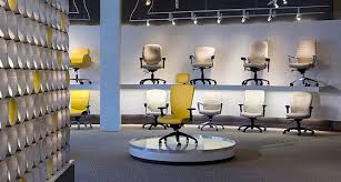 Global Total Office Manufacturer Of Office Furniture Worlwide Office Chairs Office Furn Showroom Interior Design Furniture Store Design Store Design Interior