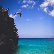 Second, the entry can be tricky as there is no sandy beach, just large boulders that are often very slick, especially during low tide (this entry can only really be done at high tide so planning is a must). Cliff Jumping At Waimea Bay On North Shore Oahu Hawaii