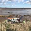 Women with blue truck stuck in mud. 1