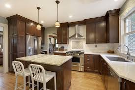This white kitchen remodel went from dark cherry cabinets and a closed off space to an open, bright space with white cabinets and reclaimed wood shelving. Choosing The Right Countertops To Match Cherry Cabinets Home Building And Remodeling Experts In Plymouth Minnesota Mn