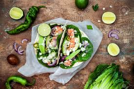 Maybe you would like to learn more about one of these? Preparing Healthy Lunch Snacks Fish Tacos With Grilled Salmon Red Onion Fresh Salad Leaves And Avocado Cilantro Sauce On Vintage Stone Background Recipe For Cinco De Mayo Party Top View Stock Photo