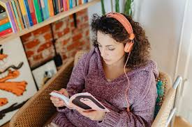 Woman with Headphones Reading a Book at Home · Free Stock Photo