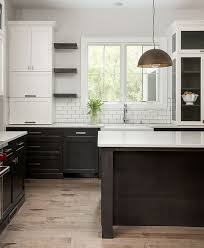 A black quartz countertop was installed for a. Kitchen Cabinets Gray Lower White Upper
