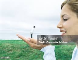 Man Standing On Womans Hand Optical Illusion High-Res Stock Photo