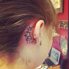 An easy to do idea of notes tattoo behind the ear. Music Notes Tattoo Designs Behind Ear
