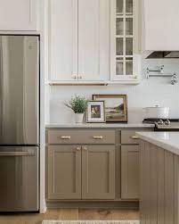 This dark taupe paint color makes the cabinets pop in nancy fuller's farmhouse kitchen. Sara S Kitchen Update Spirals Into A Full Renovation Plus Help Her Choose A Design Plan Emily Henderson Diy Kitchen Renovation Taupe Kitchen Cabinets Kitchen Design