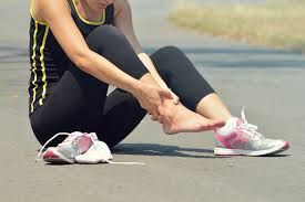 Foot Pain: Young woman suffering from an ankle injury while ...