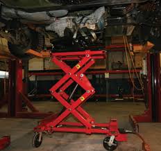 An asymmetric car hoist has arms of different lengths; Mohawk Lifts Tr 19 Tr 25 Purchase 4 Post Truck Lifts Car Lifts Four Post Vehicle Lift Contracts Mohawk Lifts