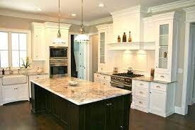 White walls and a farmhouse sink stay in color alignment with the cabinets, while the warmth of the counters plays beautifully off the hardwood flooring. 17 Best White Cabinets Dark Island Kitchen Ideas Kitchen Kitchen Design Kitchen Remodel