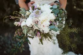 With big delicate blossoming petals, peonies work great paired in a bouquet with other cream colored flowers and eucalyptus. Yearlong Wedding Plans Go Up In Smoke Durango Weddings Magazine