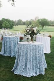 Polyester tablecloths offer matte elegance. Pale Blue Patterned Cocktail Table Linens