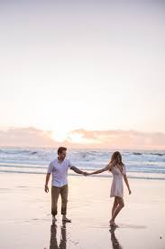 Sunset Beach Engagement Picture Couple Dancing By The Ocean Sunset Photoshoot Couple Beach Pictures Couple Beach Photos