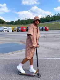 I'm so used to seeing him wear mental outfits that him in a tracksuit is more . Lewis Hamilton Wears Daring Check Outfit With Matching Hat And Shorts As Mercedes Star Scoots His Way Towards F1 Title Sporting Excitement