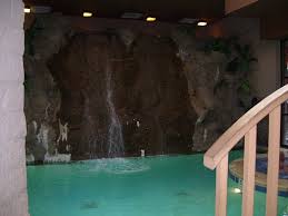 the indoor pool has a waterfall at the