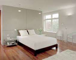 This room's design establishes a clear center point by using a square, sturdy coffee table that is a different, darker color than the rest of the room. 50 Minimalist Bedroom Ideas That Blend Aesthetics With Practicality