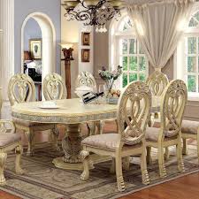Above, a white coffered ceiling mirrors the look of the room. Wyndmere Traditional Dining Table Household Furniture Dining Tables