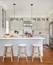 Two Clear Glass Pendants Illuminate A Light Gray Peninsula Seating Three Serena Lily Riviera B Diy Kitchen Renovation Kitchen Design Modular Kitchen Cabinets