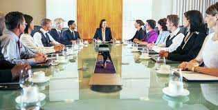 I'd like to end the bickering with a nice firm etiquette rule. Conference Participants Looking At Young Woman Sitting At Head Of Conference Table Stock Photo Dissolve