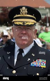 U.S. Air Force Colonel David Shevchik, commander of the 158h Fighter Wing,  addresses members of the 158th Fighter Wing and their families during a  deployment ceremony at the Vermont Air National Guard