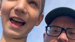 Charles McKenzie and son, Charlie, demonstrate chimpanzee call he learned  from Jane Goodall