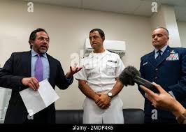 Attorneys Brian Bouffard, left, accompanied by U.S. Navy Lt. Cmdr. Aaron  Shephard, and U.S. Air Force Major Jason Cordova, speak with reporters  after the second day of an arraignment hearing for their