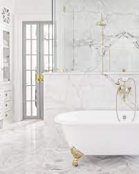 White bathroom with marble tub, sheer drapes, gold hardware + small, crystal pendants. Pin By Becki Owens On Future Bathroom White Marble Bathrooms Marble Bathroom Bathroom Inspiration
