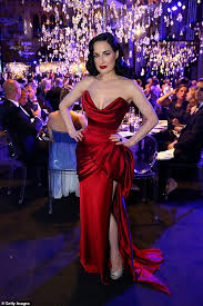 Back in 2006, rocker marilyn manson married burlesque queen dita von teese in an unconventional ceremony, all of which was captured in the pages of vogue's march issue. Dita Von Teese Oozes Glamour In A Plunging Scarlet Gown Daily Mail Online