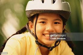 Girl On Bike With Helmet And Braces High-Res Stock Photo