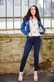 Chambray shirt with jeans & denim open toe ankle strap heels. Young Stylish Brunette Girl On Shirt Pants Jeans Jacket And High Heels Shoes Posed Background Iron Fence Street Fashion Model Concept 147056823 Larastock