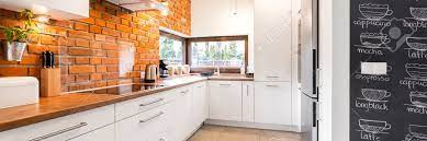 Glass bricks used in flooring are sometimes solid. Bright And Clean Modern Minimalist Kitchen With White Cabinets Stock Photo Picture And Royalty Free Image Image 65558969