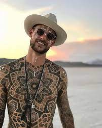 Dude Blacksymmetry With Hat Sunglasses And Geometric Bodysuit Tattoo Chilling During Sunset