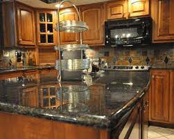 Honey oak kitchen cabinets with black countertops |. 15 Uba Tuba Granite Options To Create Elegance In Your Home