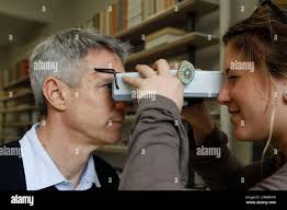 Retail associate Liane Pavilonis, right, measures the distance between Chris  Klopp's pupils for his new eyeglasses at Warbyparker.com's Manhattan  showroom in New York, Wednesday, May 4, 2011. The business is one os