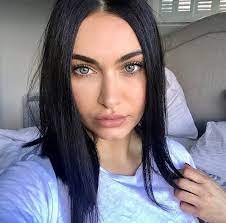Close up facial portrait of a girl with blond hair and green eyes playing with her hair on a black background. I Met An Ethnic Russian Man From Siberia With Black Hair And Dark Blue Eyes How Common Is This Quora
